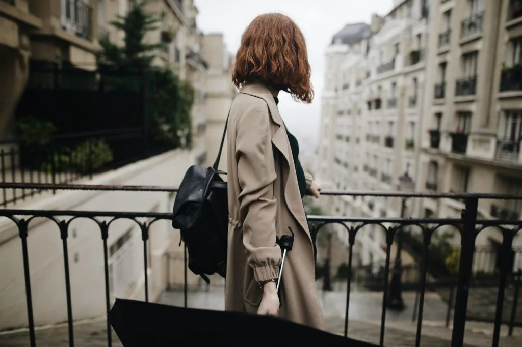 shallow focus photography of woman beside fence 1684915 scaled