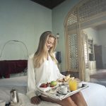 cheerful woman with breakfast on tray in hotel bedroom 3771837